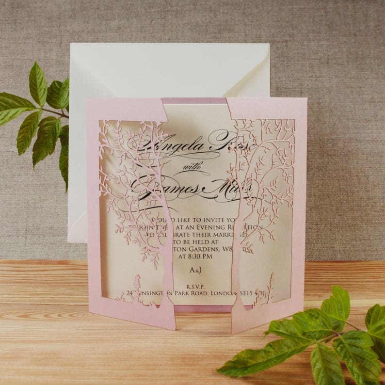May include: Pink laser cut wedding invitation with a floral design. The invitation reads "Angela K with James M" and includes the text "You would like to invite you to join us at an evening reception to celebrate their marriage to be held at ... Gardens, W8 at 8:30 PM. AsJ. R.S.V.P. 24 ... in Park Road, London SE15 4J"
