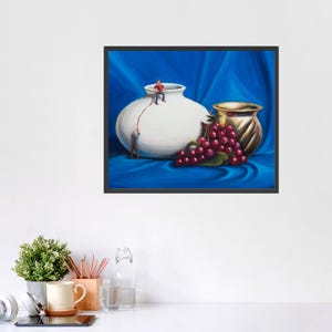 May include: A framed painting depicts a still life with a large white vase, a smaller gold vase, and a bunch of red grapes. Two miniature figures appear to be climbing the white vase with a rope. The background is a blue fabric.