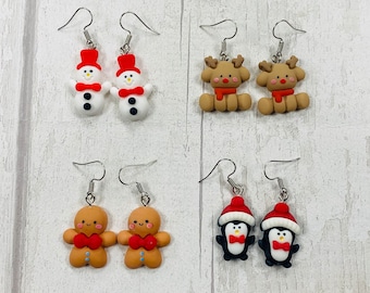 May include: Set of 10 pairs of polymer clay earrings featuring various Christmas characters. The earrings are silver and feature a snowman, reindeer, gingerbread person, and penguin.