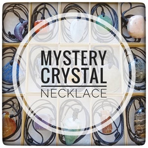 May include: A collection of 12 mystery crystal necklaces with various colors and shapes. Each necklace has a black cord and a different crystal pendant. The text "MYSTERY CRYSTAL NECKLACE" is displayed in the center of the image.