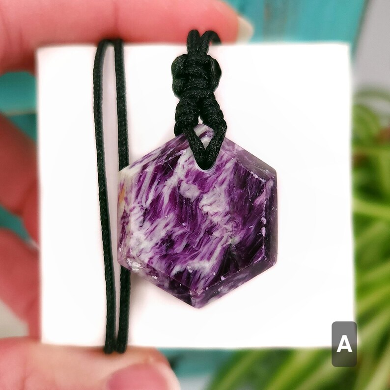 Purple, green, and cream Kammererite hexagon shaped necklace with an adjustable black nylon cord, shown against a white background.