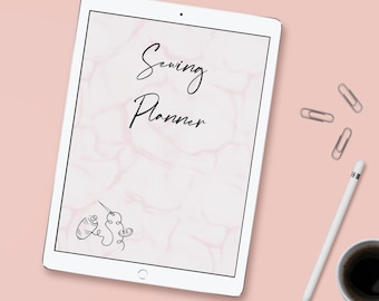 May include: A white tablet computer with a pink marble background and the text "Sewing Planner" displayed on the screen. A small illustration of a needle and thread is in the bottom left corner of the screen.