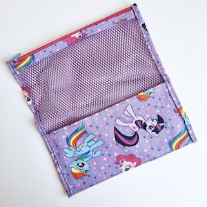 May include: Purple zippered pouch with a mesh pocket and a print of My Little Pony characters on a purple background with white stars.