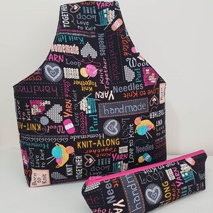 May include: A black fabric tote bag and a matching pencil case with a colorful print of yarn balls, needles, and the words "Love to Knit", "Knit Together", "Handmade", and "Knit-Along".
