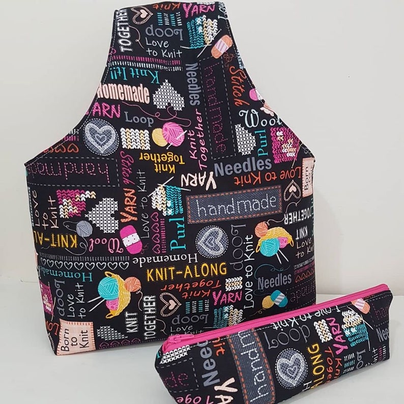 May include: A black fabric tote bag and a matching pencil case with a colorful print of yarn balls, needles, and the words "Love to Knit", "Knit Together", "Handmade", and "Knit-Along".