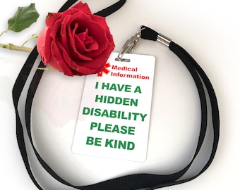 May include: A white card with the text "Medical Information I Have A Hidden Disability Please Be Kind" in black and green text. The card is attached to a black lanyard with a red rose on top.