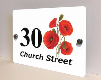 May include: White rectangular house number sign with the number "30" in black, and the words "Church Street" below. The sign features a vibrant illustration of red poppies with green stems and buds. The sign is mounted with silver hardware.