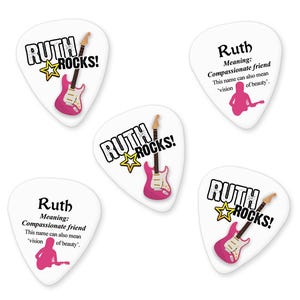 May include: Four white guitar picks with the name "Ruth" and the text "Rocks!" printed on them. Each pick features a pink electric guitar with a white star.