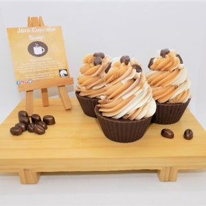 May include: Three brown and white cupcake-shaped soaps with coffee bean accents on a wooden tray. The soaps are labeled "Java Cupcake Soap" and have a coffee cup icon.