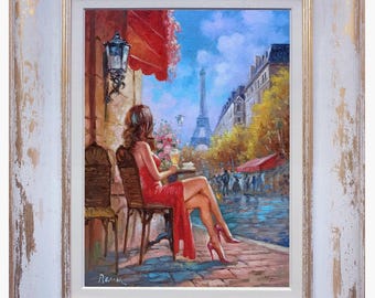 May include: Oil painting of a woman in a red dress seated at a cafe table, with the Eiffel Tower in the background. The painting is framed in a white and gold distressed wooden frame. The scene is set in Paris.