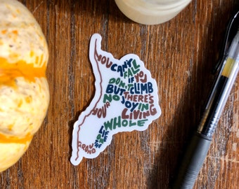 May include: White sticker with a brown, green, and blue word art design. The words say "You can't fall if you don't climb but there's no joy in living your whole life on the ground."