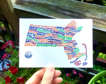 May include: A colorful word cloud in the shape of the state of Massachusetts. The word cloud includes the names of cities and towns in Massachusetts. The word cloud is on a white background. The words "Wander on Words" are in a circle at the bottom of the image.