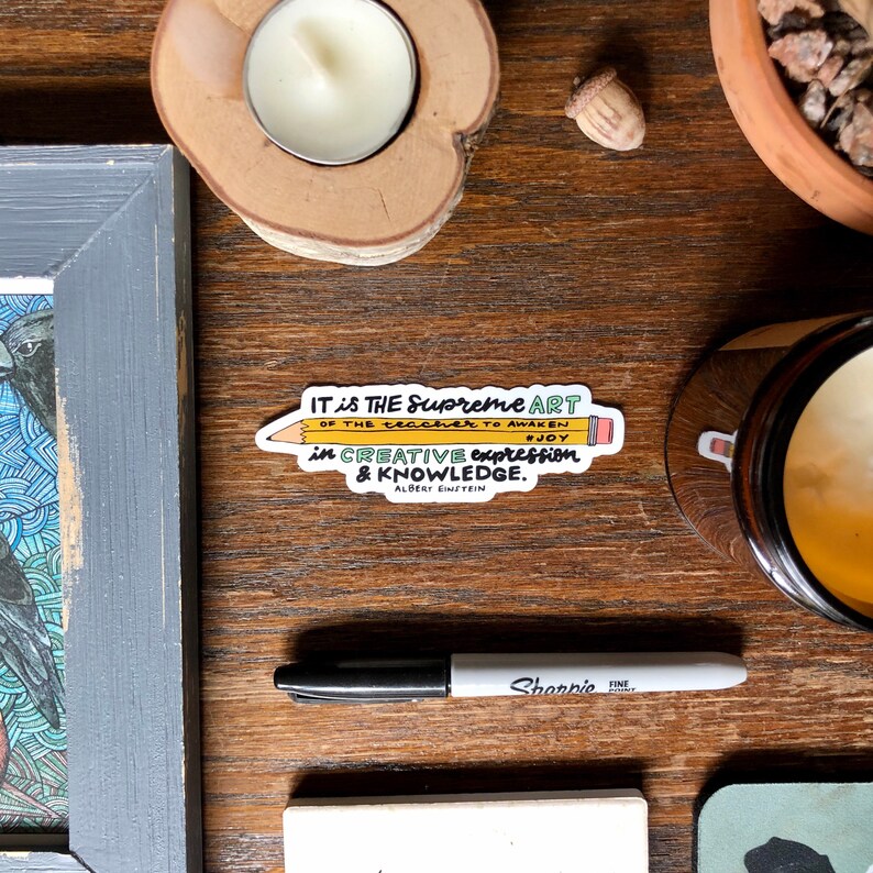 May include: A yellow pencil sticker with a quote by Albert Einstein: "IT is THE Supreme ART OF THE teacher TO AWAKEN #JOY in CREATIVE expression & KNOWLEDGE."