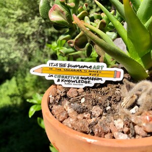 May include: A yellow pencil sticker with a quote by Albert Einstein: "It is the supreme art of the teacher to awaken joy in creative expression & knowledge."