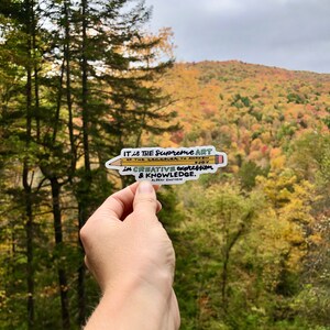 May include: A yellow pencil sticker with a quote by Albert Einstein: "IT is THE Supreme ART OF THE Teacher TO AWAKEN JOY in CREATIVE expression & KNOWLEDGE."