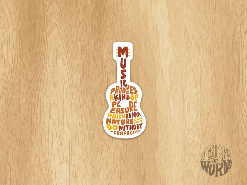 May include: A white sticker with a guitar silhouette. The guitar is filled with text that reads "Music produces a kind of pleasure which human nature cannot do without -Confucius".