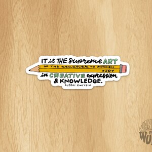 May include: A yellow pencil sticker with a quote by Albert Einstein: "IT is THE Supreme ART OF THE teacher TO AWAKEN #JOY in CREATIVE expression & KNOWLEDGE."