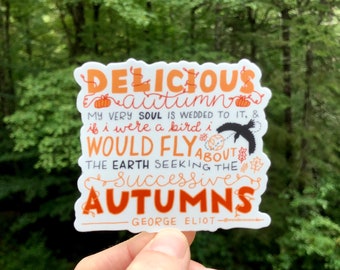 May include: A white sticker with orange and black text that reads "DELICIOUS autumn MY VERY SOUL IS WEDDED TO IT, & if i were a bird i WOULD FLY ABOUT THE EARTH SEEKING THE Successive AUTUMNS - GEORGE ELIOT - @wondermark"