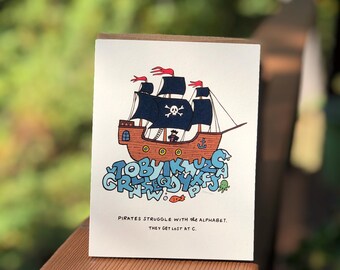 Tarjeta de felicitación con juego de palabras piratas ilustrado "Perdido en C"