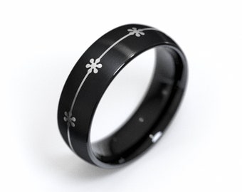 Anillo de tungsteno con corona de flores: banda negra con forma abovedada y ajuste cómodo con pequeñas flores y diseño floral original.