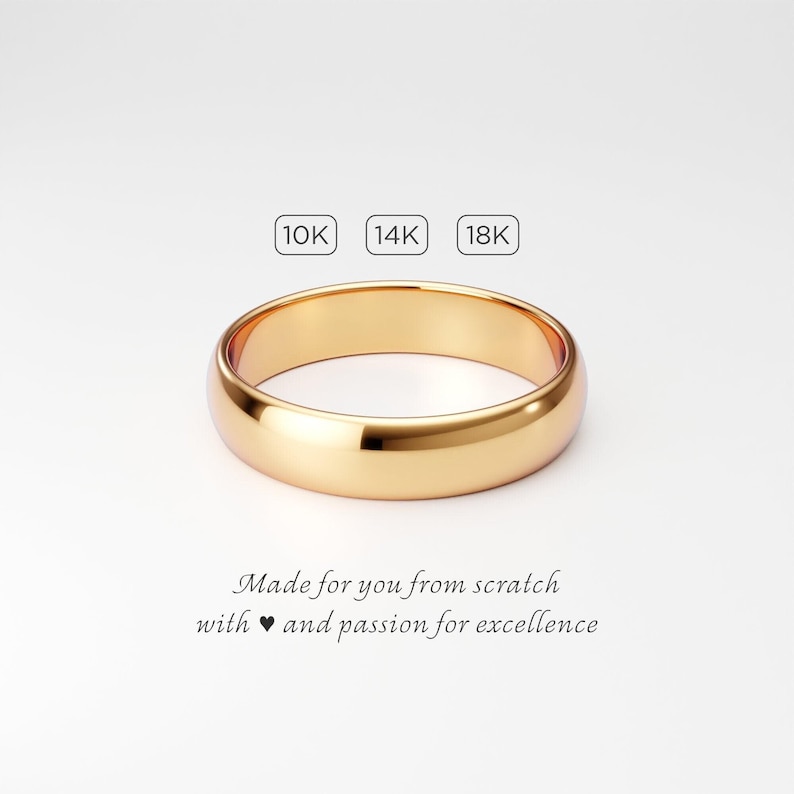 A 5mm wide solid gold wedding band for men, handmade to order in 10k, 14k, or 18k yellow gold. Simple plain classic dome ring with smooth polished finish. The ring is shown on a very light gray background with the text "Made for you from scratch with love and passion for excellence."