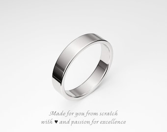 May include: A polished, silver-colored ring with a flat band. The ring is set against a white background. Text at the bottom reads "Made for you from scratch with and passion for excellence."