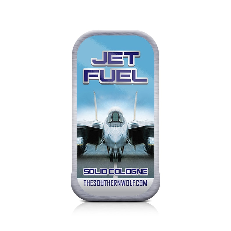 May include: A silver tin with a blue background and a jet fighter plane image. The text "JET FUEL SOLID COLOGNE" is printed on the tin. The website "THESOUTHERNWOLF.COM" is printed below the text.