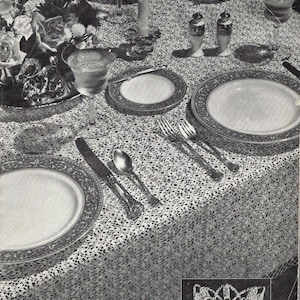 May include: A black and white photograph of a dining table set with a patterned tablecloth, plates, silverware, glassware, a candle, and salt and pepper shakers. A small inset shows a detailed crochet motif. Text reads No. 7734... 60 x 80 Inches.