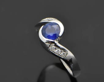 Vintage 14kt white gold ring with a beautiful blue sapphire accented with diamonds