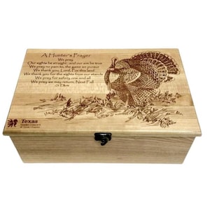 May include: A wooden box with a hinged lid and a metal latch. The lid is engraved with a turkey and a poem titled "A Hunter's Prayer". The poem reads: "We pray our sights be straight, and our aim be true. We pray no pain to, the game we pursue. We thank you, Lord, for this land. We thank you for the sights from our stands. We pray for safety one and all. We pray we may return, Next Fall."