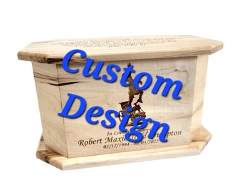 May include: A wooden box with a custom design and inscription. The inscription reads "In Loving Memory Robert Maxie Tod 05/12/1994 - 08/03/2022".