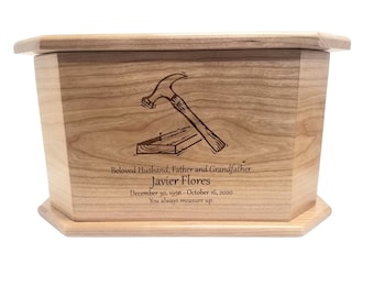 May include: A wooden cremation urn with a laser engraved image of a hammer and nails. The urn is inscribed with "Beloved Husband, Father and Grandfather Javier Flores December 30, 1956 - October 16, 2020 You always measure up."