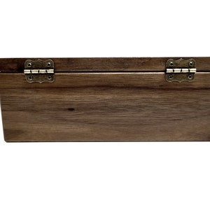 a wooden box with metal handles on a white background