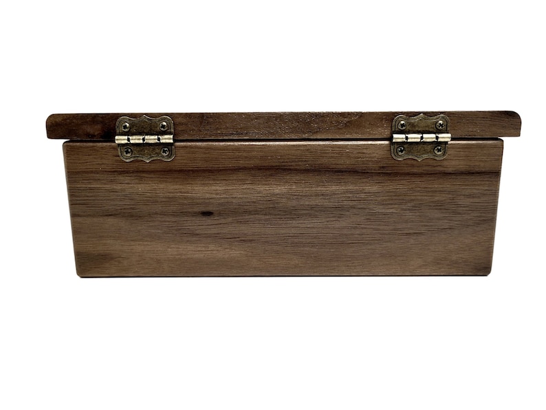 a wooden box with metal handles on a white background