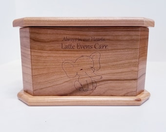 May include: A wooden box with an engraved elephant and the text "Always in our Hearts. Latte Evens Carr".