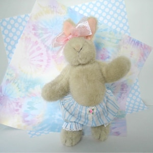 May include: A white ceramic mug with a black handle and the text "But First, Coffee" in a handwritten style. The mug is on a white surface. The mug is approximately 4 inches tall.