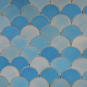 May include: A wall covered in blue and white ceramic tiles in a fish scale pattern.