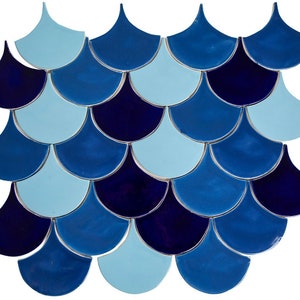 May include: A mosaic tile sheet featuring a pattern of blue and light blue fish scales. The tiles are arranged in a staggered pattern, creating a visually appealing and textured surface.