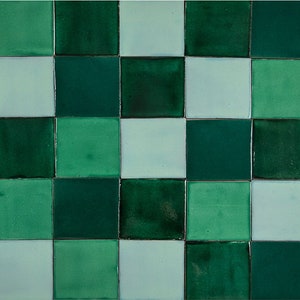 May include: A checkerboard pattern of green and light blue tiles. The tiles are arranged in a square pattern.
