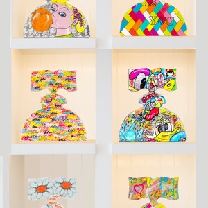 May include: Six colorful ceramic sculptures of women with different designs and patterns. The sculptures are displayed on white shelves in a white room. The sculptures are all in the shape of a woman with a large skirt and a bow on her head. The designs on the sculptures include a bubble gum, a checkered pattern, a pattern of the word "bla", a cartoon character, a daisy, and a heart.