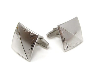 May include: A pair of silver cufflinks with a square design and an etched pattern.