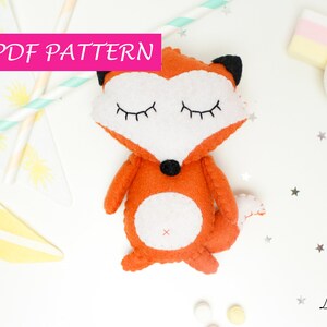 May include: A PDF pattern for sewing a cute orange fox plush toy with white accents and closed eyes. The pattern is available for download.