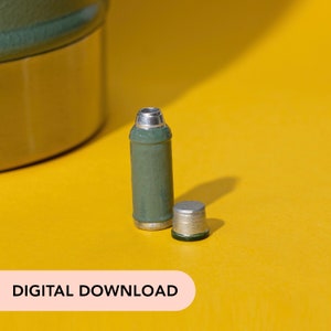 May include: A small, olive green container with a silver top and a separate, smaller silver-topped piece. The container is cylindrical and sits on a yellow background. The text "DIGITAL DOWNLOAD" is at the bottom.