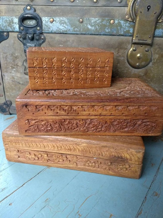 Set of three wooden carved trinket boxes 