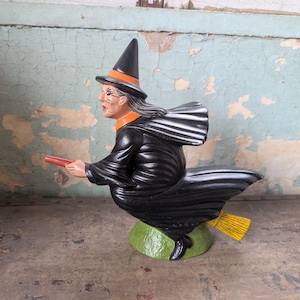 Vintage ceramic witch flying on a broom figurine
