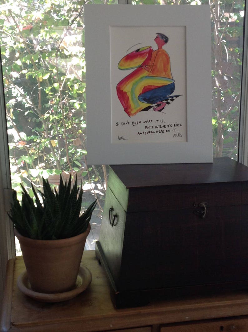 May include: A framed cartoon illustration of a person riding a rainbow-colored object. The caption reads "I don't know what it is, but I intend to ride away from here on it."