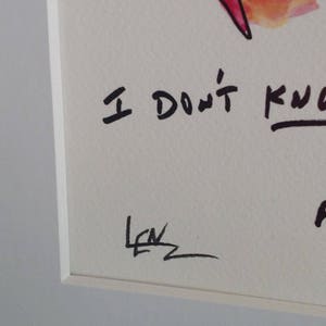 May include: A watercolor painting with a red and yellow abstract design. The text "I don't know" is written in black ink below the design. The painting is signed "Lew" in the bottom left corner.