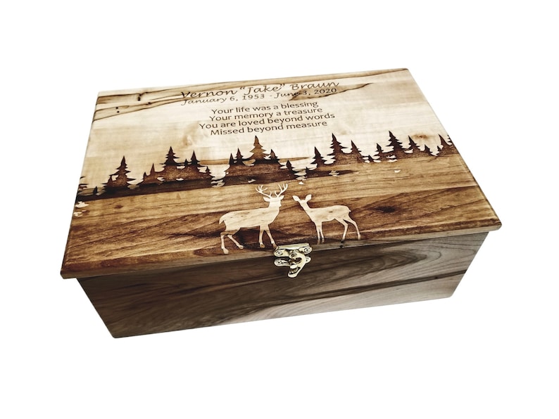 a wooden box with a picture of two deer on it