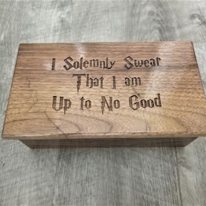 May include: A wooden box with the inscription "I Solemnly Swear That I Am Up to No Good" engraved on the top.
