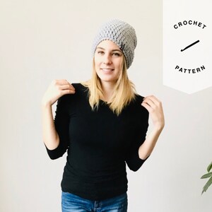 May include: A woman wearing a grey crochet beanie and a black long-sleeved top. The image includes the text "CROCHET PATTERN" in a white banner.